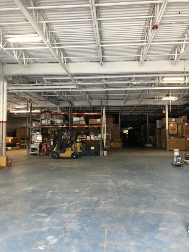 Warehouse ceiling deck after vapor blasting — clean bare metal structure