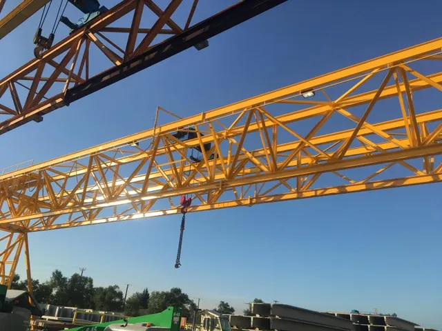 Gantry crane truss and hook over precast concrete beams in yard