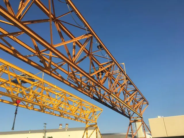 Gantry crane truss boom freshly blasted and coated yellow at IPS precast concrete facility