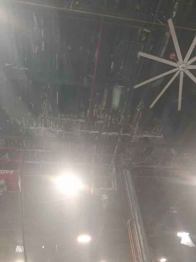 Blasted ceiling deck and exhaust fan in semi-truck maintenance bay