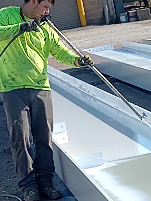 Airless spray application of coating on a structural steel channel